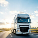 white-semi-truck-driving-highway-sunny-day